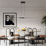 "A modern linear pendant light with a geometric design, suspended above a dining table with unique chairs, providing focused illumination."