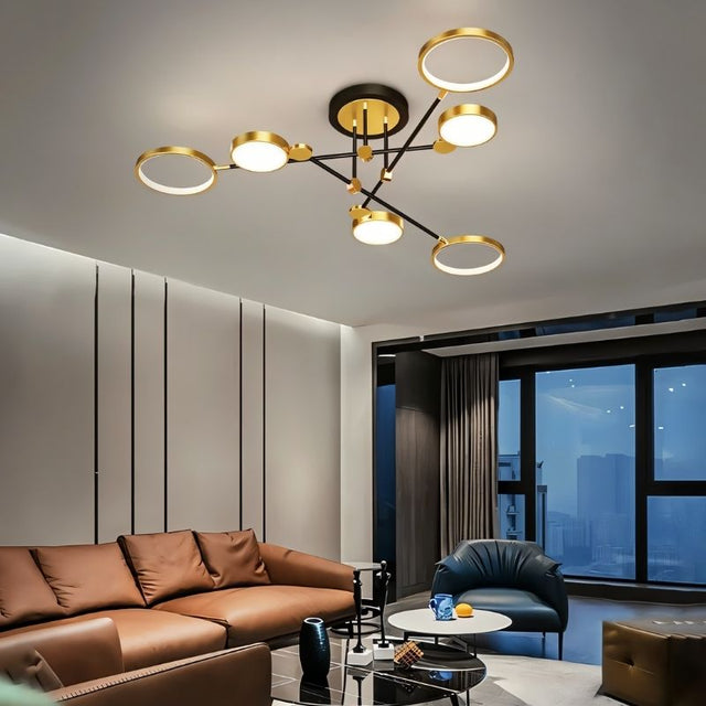 "A modern ceiling light with six circular lights and black metal accents installed in a living room with a brown leather couch and large windows."