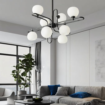 "A modern black chandelier with spherical glass shades in a contemporary living space."