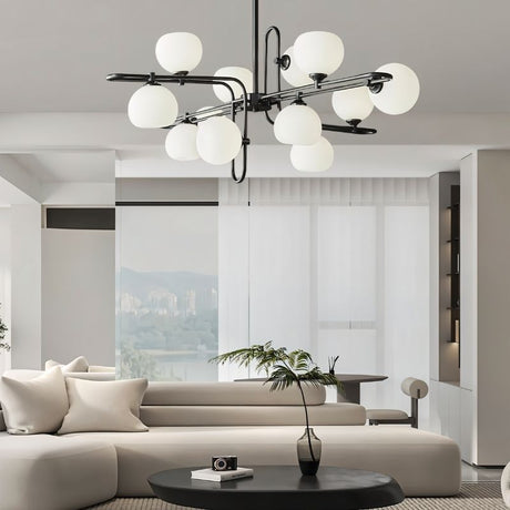 "A modern chandelier with spherical glass shades and a black metal frame in a contemporary living room."