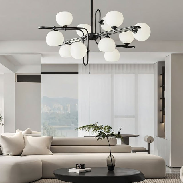 "A modern chandelier with spherical glass shades and a black metal frame in a contemporary living room."