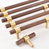 "dark wood pull bars with polished brass fittings, showcasing a sleek and refined design."