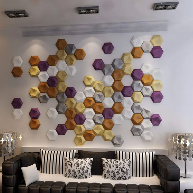 Uayal Wall Panel - Stylish, Noise-Reducing Geometric Design in purple, gold, and white hexagons enhances a white wall above a black leather couch.