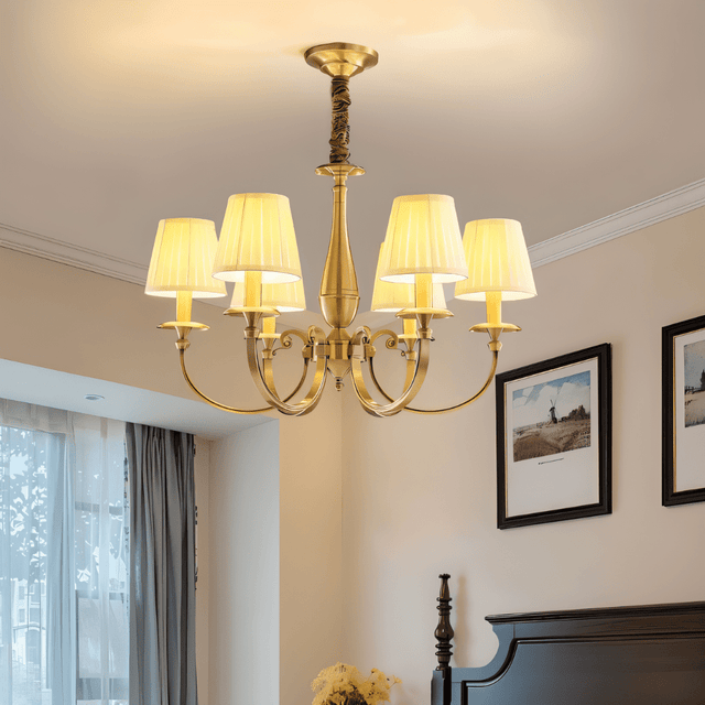 Uloma Chandelier – Elegant Lighting For Luxe Interiors installed in a bedroom with classical decor and framed wall art.