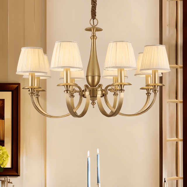 Uloma Chandelier – Elegant Lighting For Luxe Interiors hanging above a dining table in a warmly lit traditional interior.