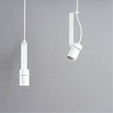 "Two white pendant lights, one straight and one oblique, showing their different orientations and minimalist design."