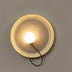 Cream-colored pendant light with textured interior and glowing white bulb against gray wall.
