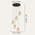 Multi-pendant chandelier with five amber crystal globe shades and black metal fixtures on cream background.