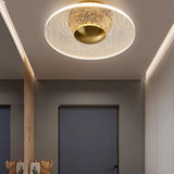 "A ceiling light with a cracked-glass effect diffuser, illuminating a modern hallway with soft ambient light."