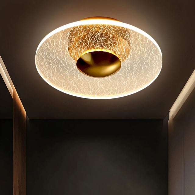 "A ceiling light with a cracked-glass effect diffuser, providing ambient illumination in a modern hallway."
