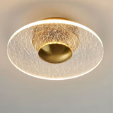 "A disc-shaped ceiling light with a cracked-glass effect diffuser, providing ambient illumination."
