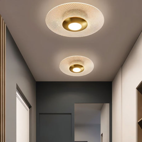 "Two patterned ceiling lights with a modern design, providing ambient illumination in a hallway."