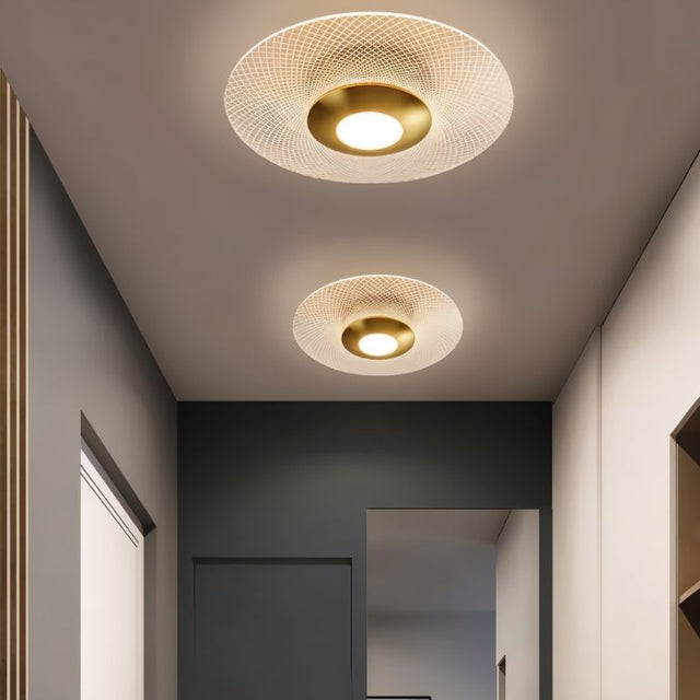 "Two patterned ceiling lights with a modern design, providing ambient illumination in a hallway."