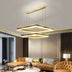 Modern gold square pendant chandelier with dual tiers suspended in contemporary living room with tan walls and caramel leather sofa.