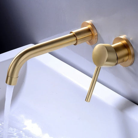Brushed gold Vartay Bathroom Faucet with water running, featuring a modern wall-mounted design above a sink.