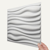 Vefni Panels - Durable, Modern Design for Any Space. Close-up of a single white Vefni PVC wall panel with modern 3D wave design held by hand.