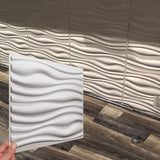 Vefni Panels - Durable, Modern Design for Any Space. Hand holding a single white Vefni panel in front of a wall installation showing matching wave pattern.
