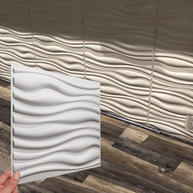 Vefni Panels - Durable, Modern Design for Any Space. Hand holding a single white Vefni panel in front of a wall installation showing matching wave pattern.