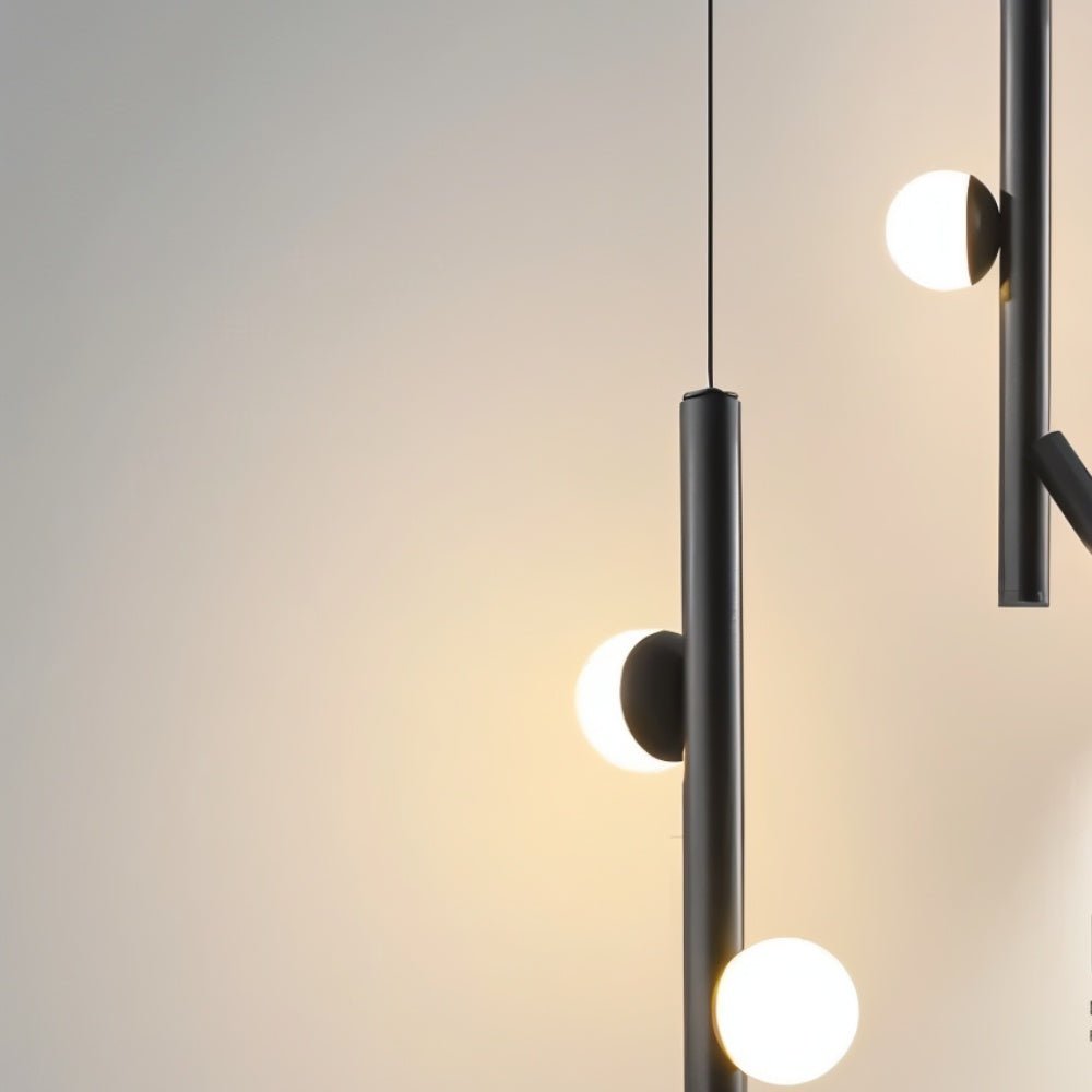 "Close-up of a sleek, iron and acrylic pendant light with cylindrical rods and glowing orb accents, showcasing its modern design."