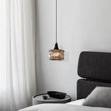 "A pendant light with a rippled glass shade providing ambient lighting in a bedroom."