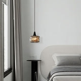 "A pendant light with a rippled glass shade in a modern bedroom decor setting."