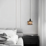 "A pendant light with a rippled glass shade in a modern bedroom interior."