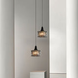 "Two pendant lights with rippled glass shades grouped together."