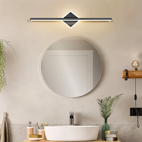 "A modern black wall lamp with a diamond-shaped base and horizontal bar, mounted above a round mirror and a white vessel sink in a contemporary bathroom."