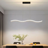 "A modern LED pendant light with an undulating wave design, illuminating a dining table with place settings and a plant."