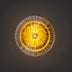 Yellow starburst wall lamp with concentric metal rings on a dark neutral background.