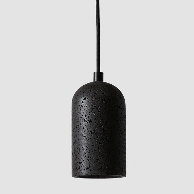 "Modern cylindrical pendant light crafted from black travertine, showcasing its natural, textured surface."