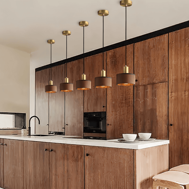 Row of Vesil Copper & Wood Pendant Light Fixtures over a kitchen island, blending modern and Japanese-inspired design.