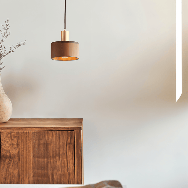 Vesil Copper & Wood Pendant Light Fixture above a minimalist wooden cabinet, ideal for bedroom or living room ambiance.