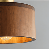 Detailed view of Vesil Copper & Wood Pendant Light Fixture's wood grain and brass top, showcasing craftsmanship.