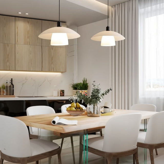 "Two layered glass pendant lights hanging above a dining table in a modern dining room."