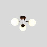 "A 3-light ceiling light with spherical glass shades and a black iron frame."
