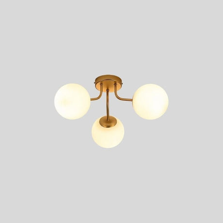 "A 3-light ceiling light with spherical glass shades and a gold iron frame."