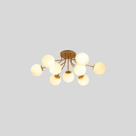 "A 9-light ceiling light with spherical glass shades and a gold iron frame."