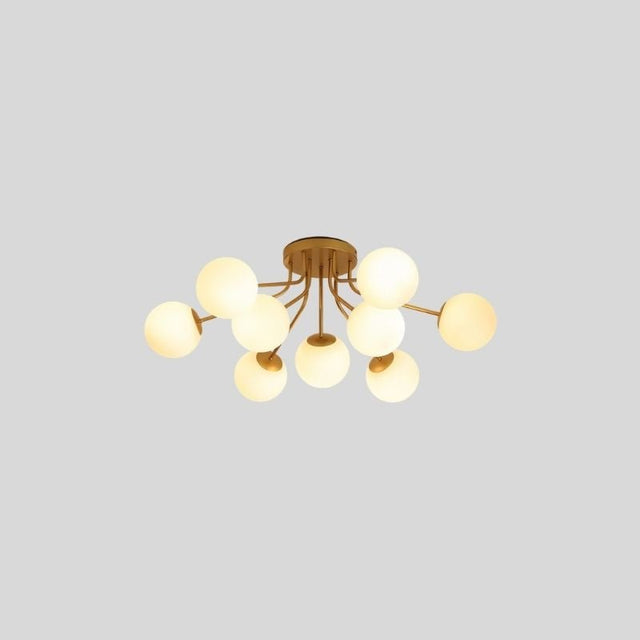 "A 9-light ceiling light with spherical glass shades and a gold iron frame."