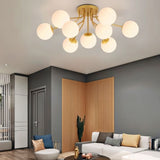 "A gold ceiling light with spherical glass shades in a modern living room."