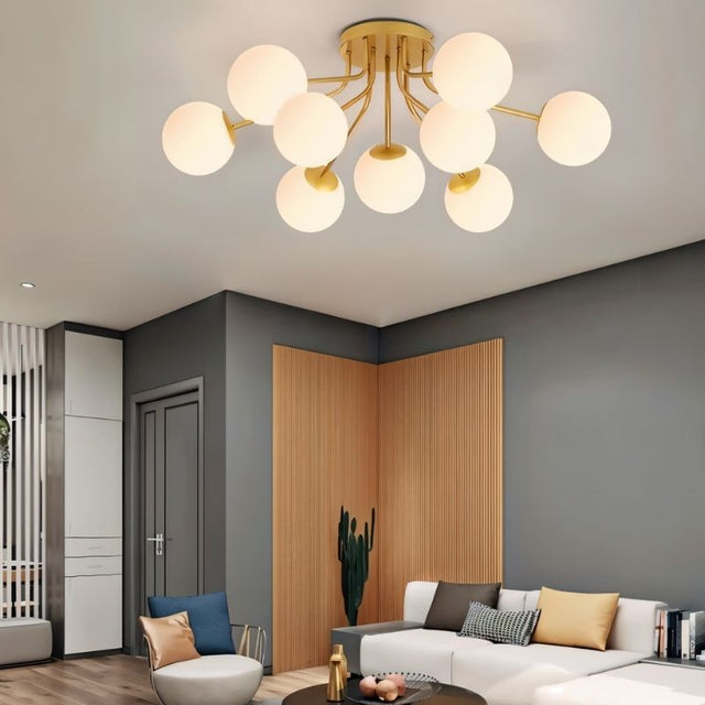 "A gold ceiling light with spherical glass shades in a modern living room."