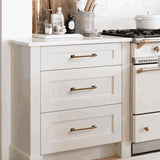 "Vintage brass pull bars with a sleek, modern rectangular design, installed on white kitchen drawers, adding a luxurious and functional touch to the space."