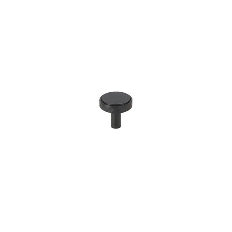 "A black faceted brass knob with a diamond-cut texture, isolated on a white background."