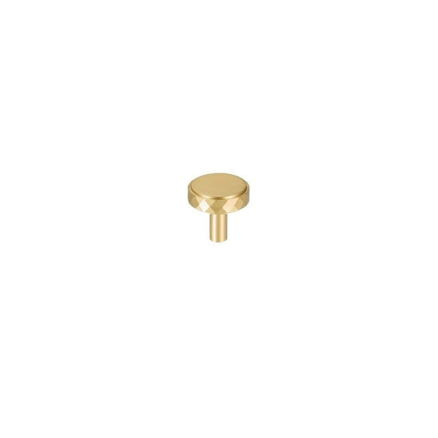 "A gold faceted brass knob with a diamond-cut texture, isolated on a white background."