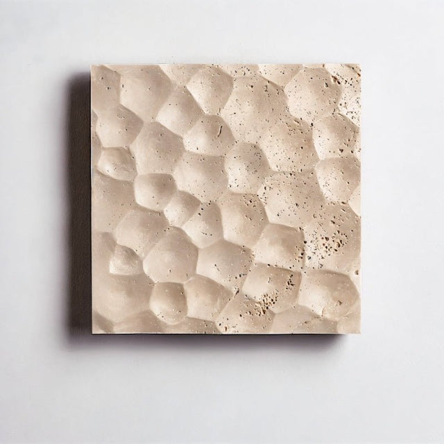 "A square travertine wall lamp with a textured hexagonal surface, isolated on a white background, showing the natural stone pattern."
