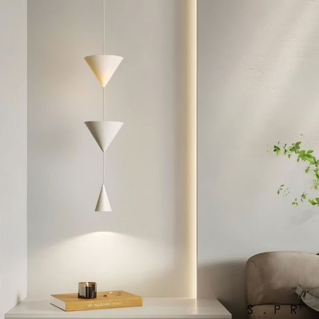 "Modern pendant light with stacked conical shades in a minimalist bedroom setting, providing a focused yet ambient glow."