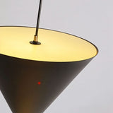 "Close-up detail of a modern pendant light featuring a conical shade, showcasing its elegant design and ambient glow."
