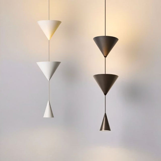 "Modern pendant lights with stacked conical shades in black and white finishes, creating a balanced and elegant design."