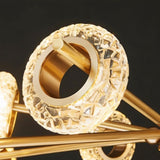 "Close-up of a circular textured glass accent on a modern gold chandelier."