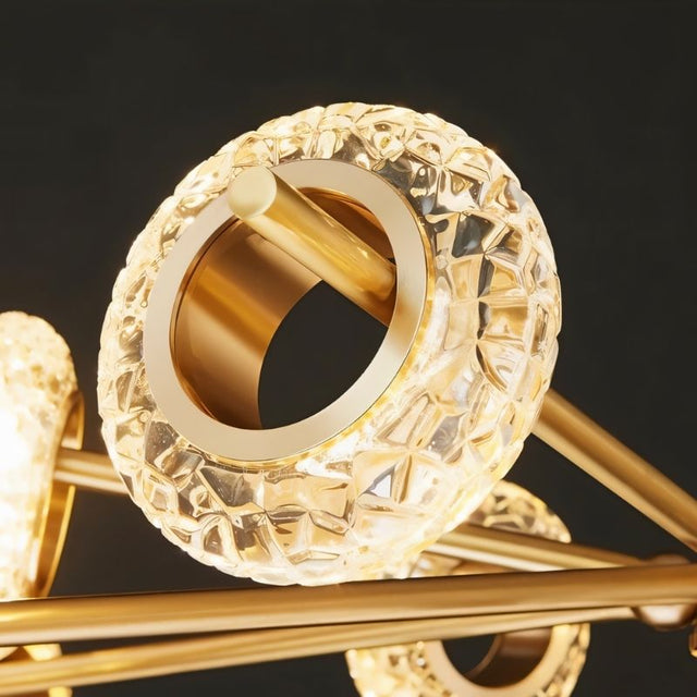 "Close-up of a circular textured glass accent on a modern gold chandelier."